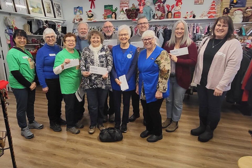 Armstrong Spallumcheen Healthcare Auxiliary volunteers at the Bargain Bin in Armstrong (in blue) handed out $200,000 in donations to healthcare and wellness organizations in the North Okanagan-Shuswap Monday, Dec. 4. Groups representing food programs collected $43,000 in donations. (Roger Knox - Morning Star) 