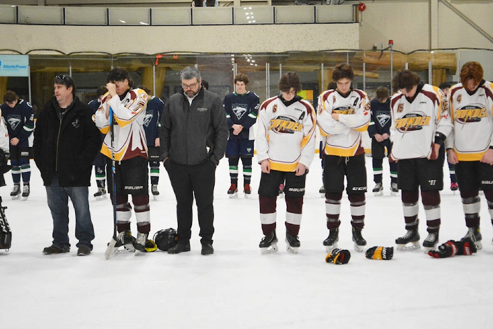 Quesnel Thunder coaches and players pause for a moment of silence during a ceremony Friday, Dec. 1 in Williams Lake honouring a member of the team, Lane Wiggins, 17, who died in a motor vehicle incident near Quesnel Sunday, Nov. 26. (Monica Lamb-Yorski photo - Williams Lake Tribune) 