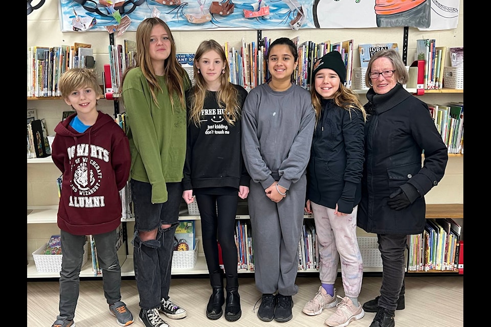 Six students from École Nesika Elementary won the National Youth Remembrance Contest. From left to right, Luke Hoeft, Lily Anderson, Luna Monteith, Keerat Kaur, Olivia Zurak, and Legion Branch 139 representative Sandra Abbott. Missing from the photo is winner Mya Kuttnick. (Photo submitted) 
