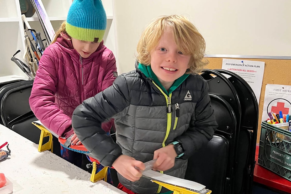 Violet Burkey, left, and Mica Wallin, learn how to scrape the wax from cross country skis during a work bee and demonstration at Bull Mountain Cross Country ski area’s new daylodge in preparation for the upcoming 2023-24 ski season. Both are members of the Jackrabbits program and members of the Williams Lake Cross Country Ski Club. (Guy Ridler photo) 