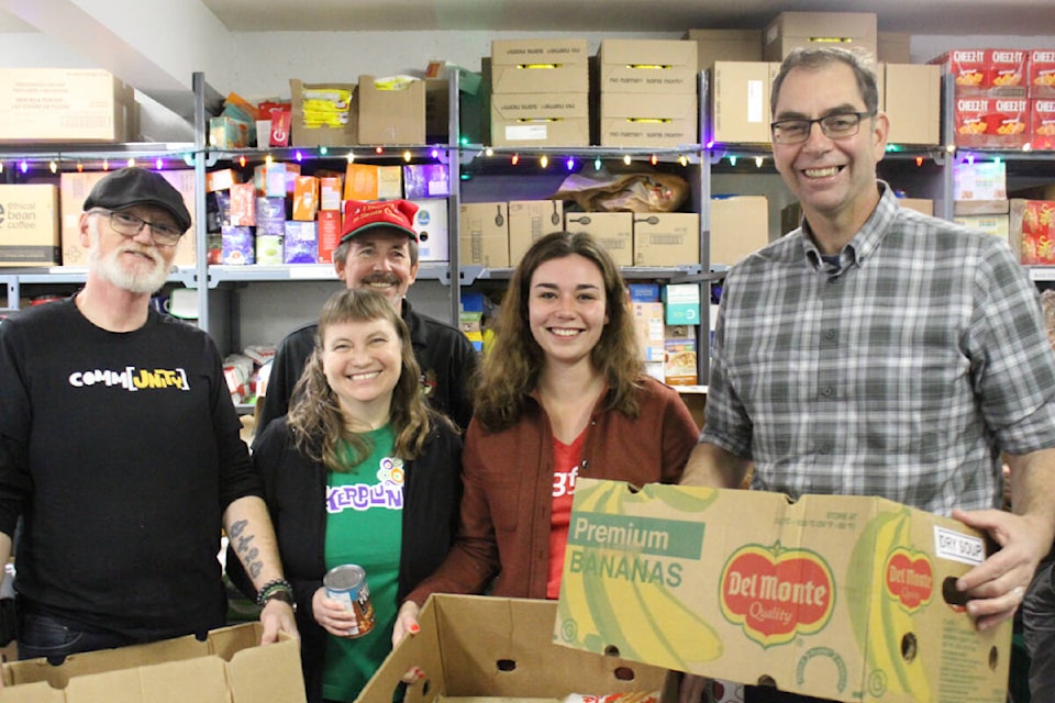 Members of the Langford City Council rolled up their sleeves and helped to pack food for people in need at the Goldstream Food Bank. (Thomas Eley/News Staff) 
