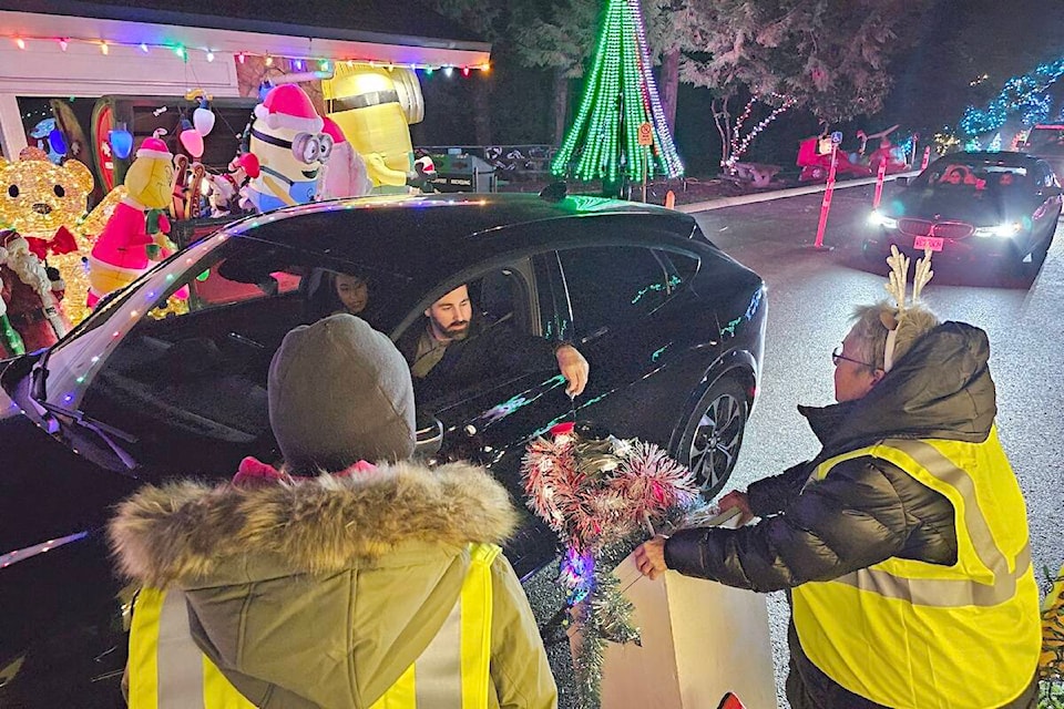 A visitor made a donation at Christmas in Williams Park during the first weekend of the annual event. Attendance is up at the annual lights display, which wraps up this weekend. (91ԭ Advance Times files) 