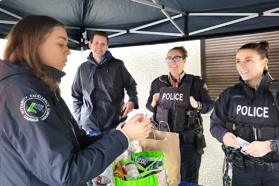 Kendall Sewell, vice principal at Brookswood Secondary, drew the winner of the raffle at the “Cram teh Cruiser” food drive event on Thursday, Dec. 7. (Kyler Emerson/91ԭ Advance Times) 