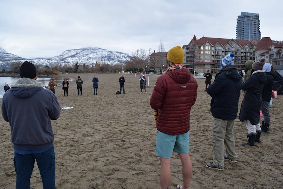 Cold Dip Kelowna gathers for a short meditation circle before plunging into the cold water. (Brittany Webster/Capital News) 