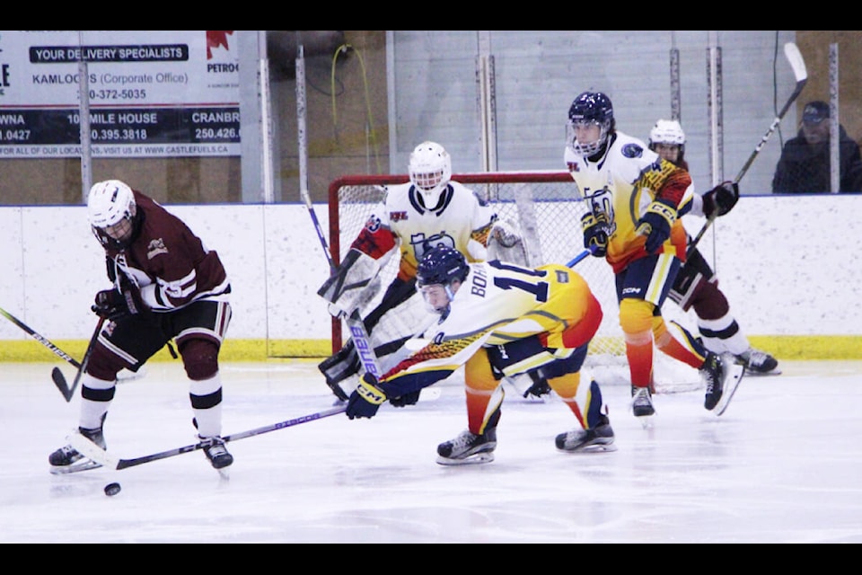 The 100 Mile House Wranglers and Revelstoke Grizzlies clash during a game on Saturday. (Patrick Davies photo - 100 Mile Free Press) 