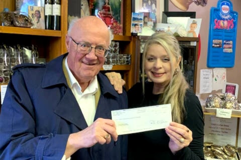 Morning Star publisher Keith Currie donates $1,390 to Baritta Durward of Cotton’s Chocolates and the Sweet Smiles Society. The money, raised through the sale of leftover Valley Vonka chocolates at the Father Daughter Ball, is to purchase mattresses for the under privileged in Cuba. (Contributed) 