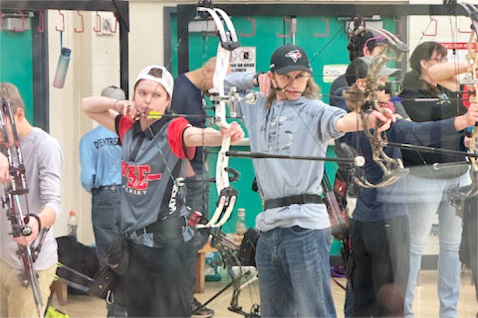 Lily Fraser, centre left, takes aim while shooting at a qualifying event in Prince George recently. (Cara Fraser photo) 
