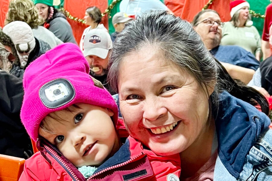 Emzii Myers, 2, gets cuddles from her grandma, Tiffany Haines at the annual Yuletide Dinner Dec. 6, hosted by the Cariboo Chilcotin Child Development Centre, with the support of local volunteers, businesses and St. Vincent de Paul. (Angie Mindus photo - Efteen) 