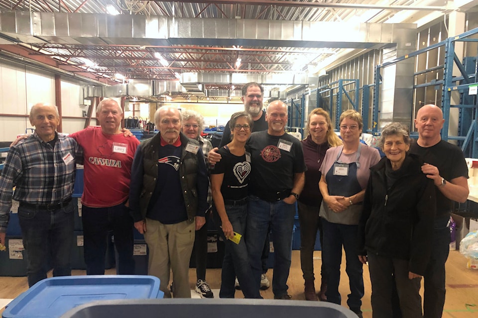More than a dozen volunteers gathered on the second floor of the Comox Valley Dodge to finalize the assembly of the last hampers for this year’s edition of the Sharing the Christmas Spirit Hamper Program. (Olivier Laurin / Comox Valley Record)  