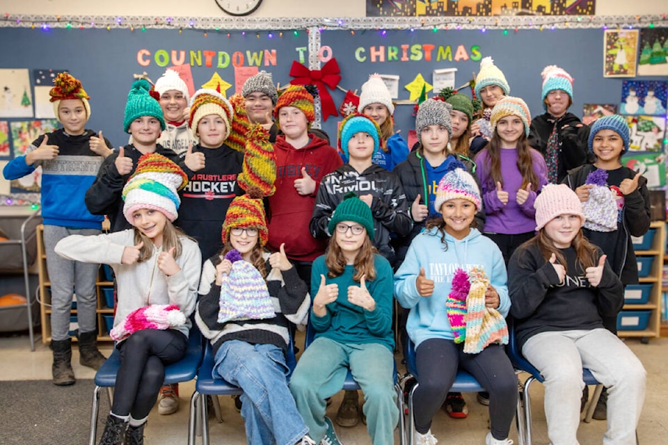 Students at Laity View Elementary wear some of the toques they made for people living on the Downtown Eastside in Vancouver. (Jasmine Bala/SD42/Special to The News) 