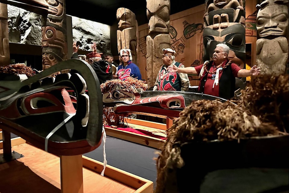 Chiefs Paddy Walkus, Willie Walkus, and David Nolie stand by the carvings and regalia. (Submitted photo) 