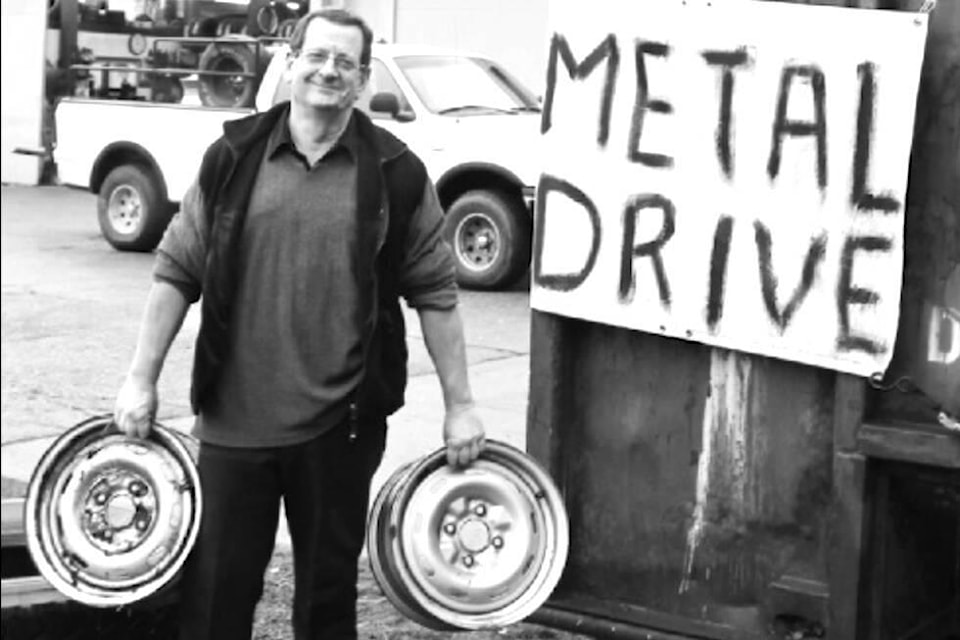“Dave Darling, owner of OK Tire and Auto Service, adds to the Chamber’s metal drive bin. The bin will remain at OK Tire while the drive continues until the end of December.” (Lake Cowichan Gazette/Dec. 19, 2013) 