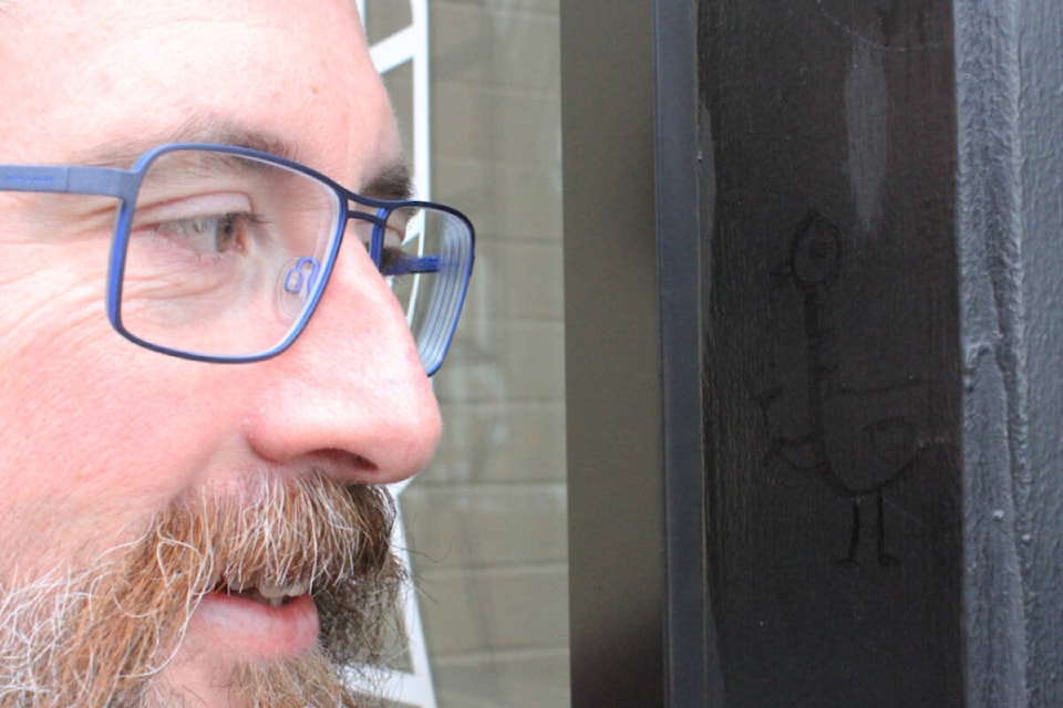 Swans Pub owner Mike Boyle has embraced the four-inch graffiti image of a bird on the outside of his bar by turning it into their new logo. (Ella Matte/News Staff) 