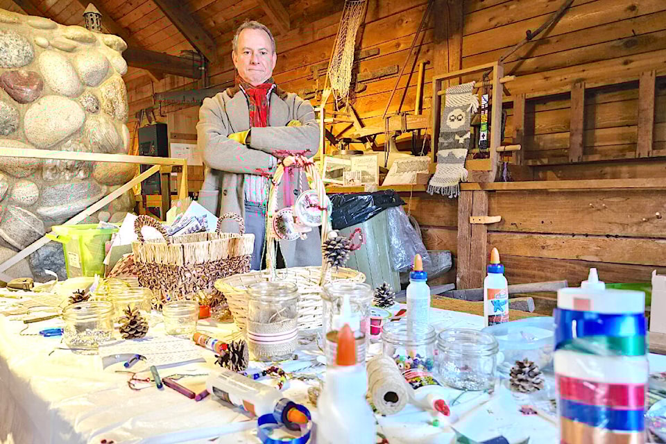 Historial re-enactor Antoine Lemieux, in character as the grumpy chief trader at Fort 91ԭ, casts a disapproving eye on the Christmas craft table in the fort’s cooperage building. It was part of a “Humbug Christmas” at the historic site. (Dan Ferguson/91ԭ Advance Times) 