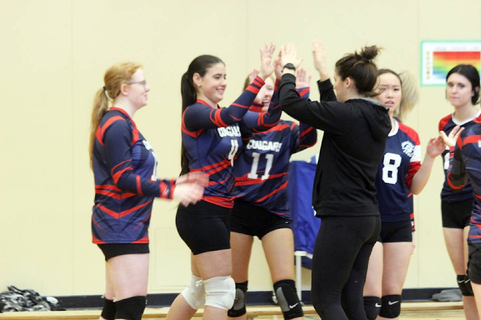 Coach Jill Astren high fives her senior girls players. (Photo by Don Bodger) 