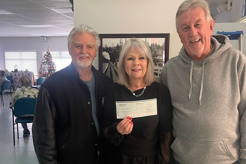 White Rock Elks president Al Burns, left and Elks committee head for charity and fundraising Bob O’Keefe presented a $1,000 cheque to Brellas Community Services executive director Louise Tremblay on Tuesday (Dec. 19). (Contributed photo) 
