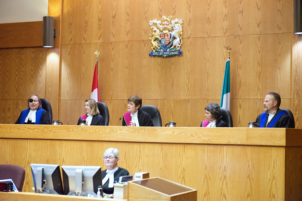 Chief Justice Suzanne Duncan of the Supreme Court of Yukon (centre) speaks to Chief Justice Leonard Marchand during his swearing-in ceremony as chief justice for the Court of Appeal of Yukon. From left to right: Chief Judge Michael Cozens, Justice Edith M. Campbell, Chief Justice Suzanne Duncan, Justice Karen Wenckebach and Judge John Phelps. (Matthew Bossons/Yukon News) 