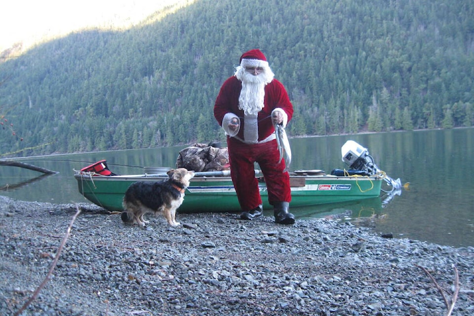 For three decades, Larry Horvath has managed to (mostly) keep his identity as the Cameron Lake Santa a secret. He used to spend Christmas Day with his furry companion. (FACEBOOK PHOTO) 