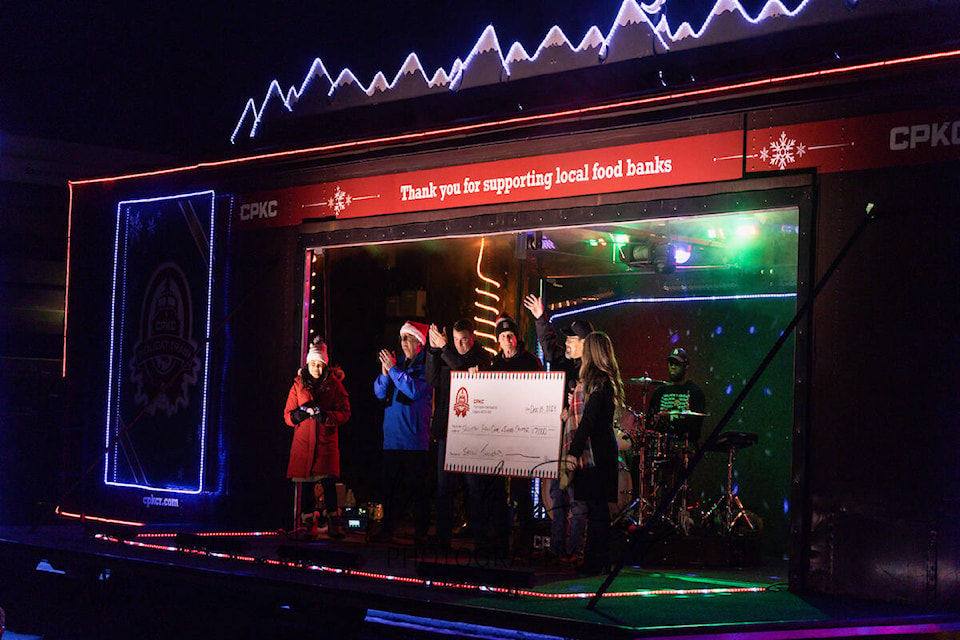 Local dignitaries MP Mel Arnold, MLA Greg Kyllo and Salmon Arm Mayor Alan Harrison ‘cheque’ out the $7,000 donation to the Salvation Army food bank from CPKC at the at the Holiday Train stop in Salmon Arm on Friday, Dec. 8. (Kayleigh Seibel Photography) 