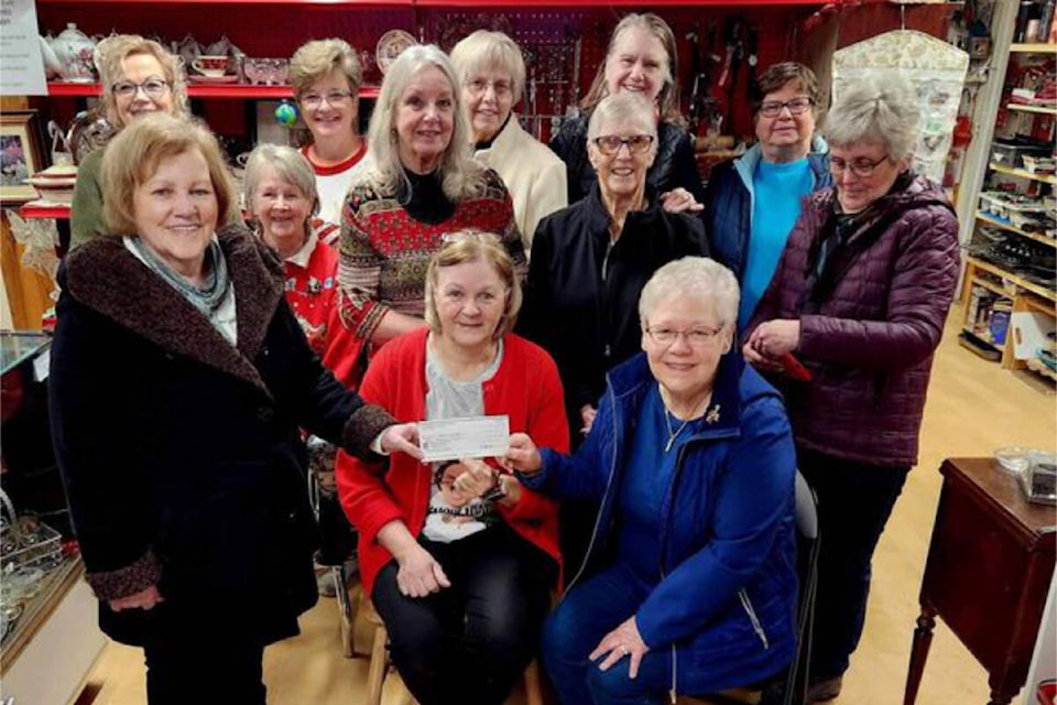 Clearwater Curiosity Thrift Shoppe members stand behind manager Lori Redman (c) as she presents a cheque for $40,000 to Dr. Helmcken Memorial Hospital Auxiliary president Marilyn Collison (l) and DHMHA director Sue Ludtke (r). (Photo submitted) 