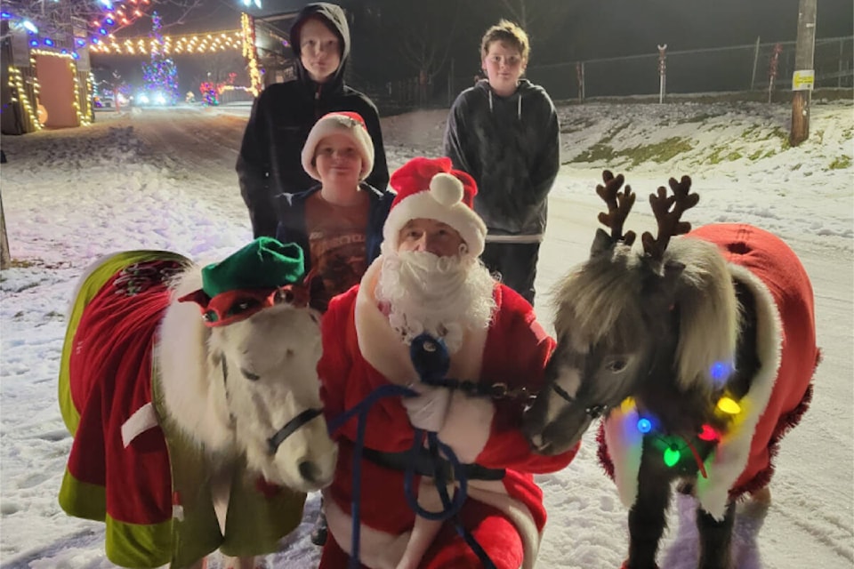 Santa’s ponies at the Christmas Light Up which opened on Dec. 15 and goes till Dec. 23 then back open again on Dec. 27 - 30 weather permitting. Walk or Drive Thru and enjoy the beautiful light show and holiday spirit while you warm up at the bonfire sipping hot chocolate and singing carols with your family. The ‘Murphy Kids’ seen here behind Santa and the ponies at the fairgrounds in Barriere. (Photo by: Bev Murphy) 