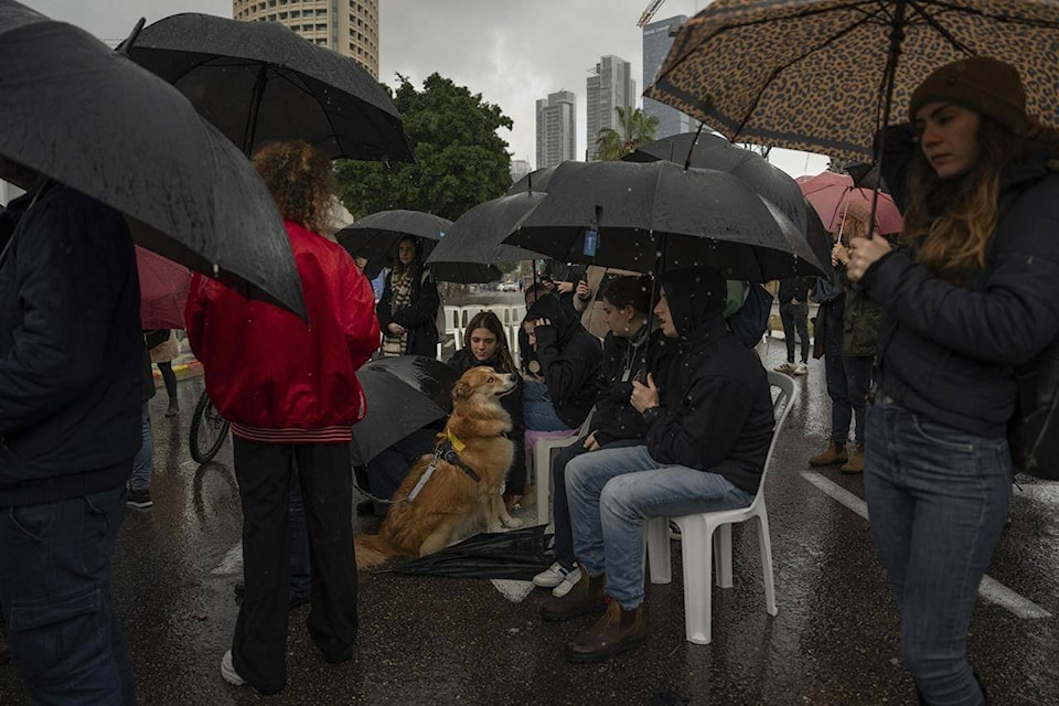 People attend a 24 hour rally calling for the release of the hostages kidnapped by Hamas militants into the Gaza Strip, in Tel Aviv, Israel, Sunday, Jan. 14, 2024. Sunday marks 100 days of war between Israel and Hamas, after Hamas attacked Israel on Oct. 7th, killing some 1,200 people, mostly civilians, and taking 250 others hostage. In the Gaza Strip, health authorities say the death toll already has eclipsed 23,000 people. (AP Photo/Oded Balilty) 