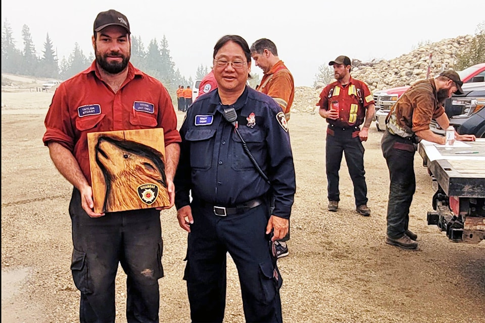 Sicamous Fire Chief Brett Ogino expresses his gratitude to Taylor Stuart and the Rhinos wildfire crew, which had been working on the Two Mile Road wildfire south of Sicamous. (Sicamous Fire Department photo) 