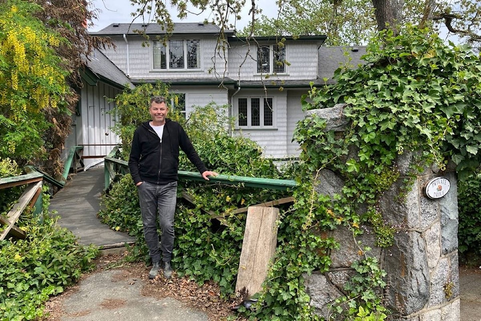 Owner Mike Miller poses outside of the home. (Oak Bay News file photo) 