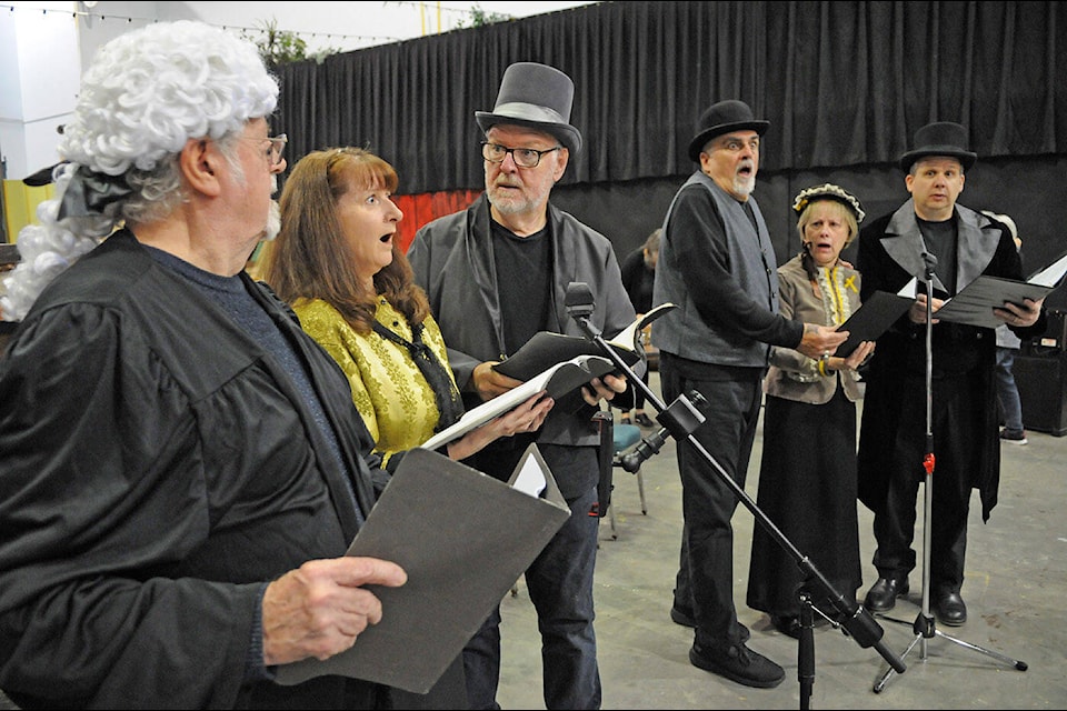Members of the Chilliwack Players guild rehearse for their upcoming radio play ‘The Gallows Does Well’ on Dec. 16, 2023. They will present the play on Jan. 13 at the Chilliwack Cultural Centre. (Jenna Hauck/ Chilliwack Progress) 