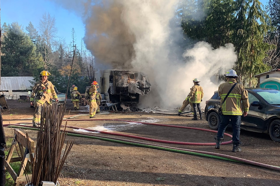 In the late morning of Dec. 31, a trailer home at the end of Courtenay’s Leash Road burst into flames. (Terry Farrell / Comox Valley Record) 