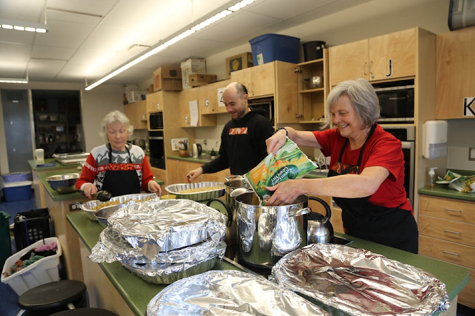 Volunteers help prepare the food for the Lake Trail Community School Winter Feast, held just before Christmas. Photo courtesy School District 71 