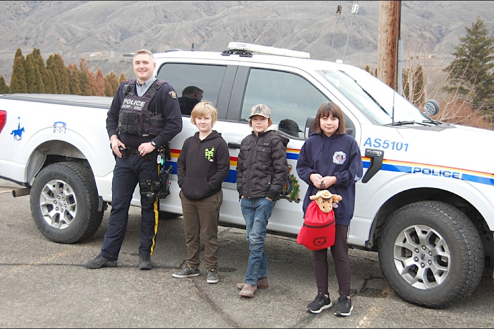 (top left, from l) Cst. Richard Wright, Arden Rowe, Liam Olsen, and Michaela Aie in front of the Ashcroft RCMP detachment’s F-150 pickup that will be named ‘Aurora’.