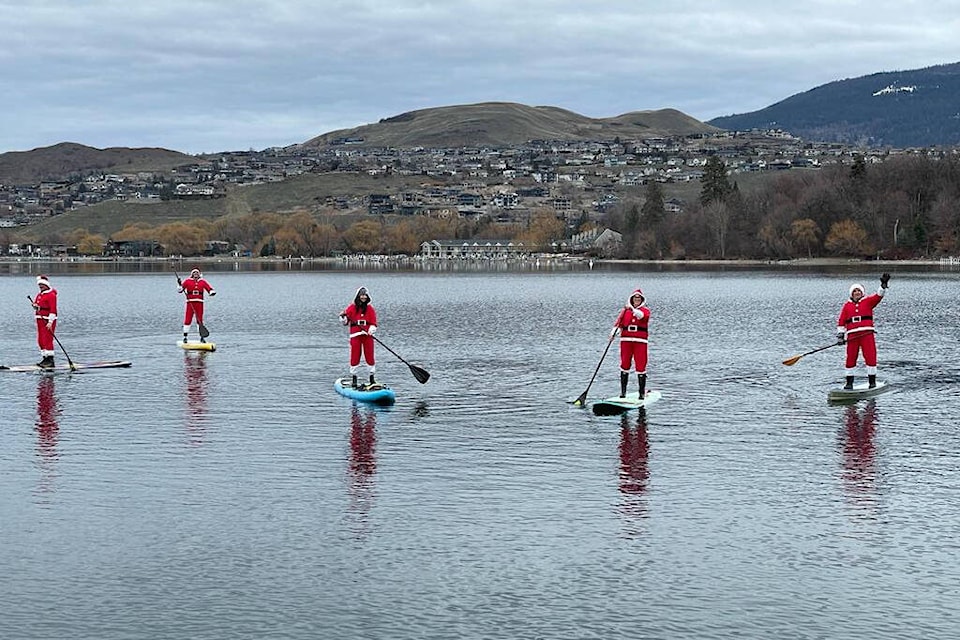 Five paddleboarders dressed up as Santa Claus were spotted on Kalamalka Lake in Coldstream during the Christmas season. The Kinlock Drive Santa Paddle was an inaugural event in 2023. (Jacqui Stephenson photo) 