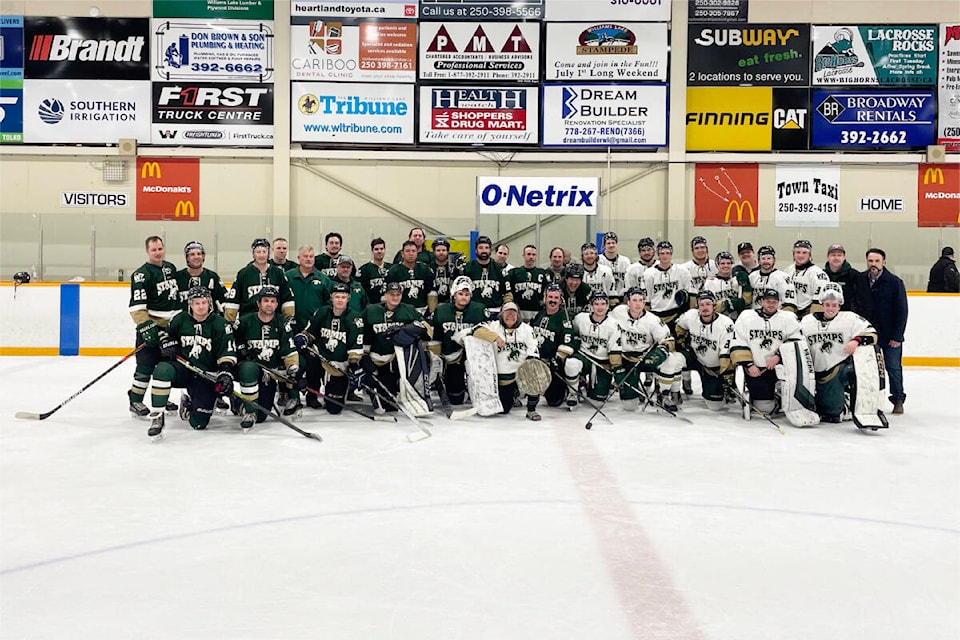 Stamps Alumni, in green jerseys, alongside the current Williams Lake Stampeders, in white, pose for a photo after a friendly game between Stamps of past years, versus the current team. (Ruth Lloyd / Williams Lake Tribune) 