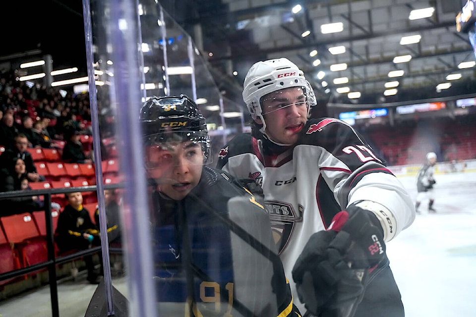 Giants forward Tyler Thorpe takes a Wheat Kings player into the boards. Thorpe scored a team-leading 18th goal of the season as Brett Mirwald backstopped Vancouver Giants to a 4-0 shutout road trip win over the Brandon Wheat Kings on Saturday, Jan. 6, with a 48-save performance. (Scramble Studio/Special to 91ԭ Advance Times) 