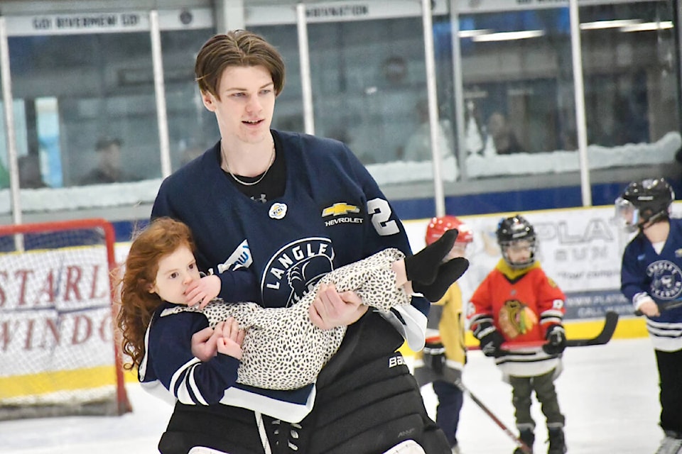 It was family skate night on Sunday, Jan. 7 at George Preston arena, a chance for kids to have a close encounter with the team, and one girl with no skates still got on the ice, experiencing a high-altitude view as she was carried around the rink by 6’ 7” Rivermen goaltender Liam Hallett. (Dan Ferguson/Langley Advance Times) 