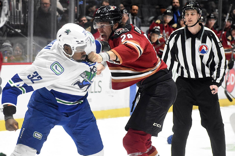 Abbotsford’s Jermaine Loewen tussles with Tucson’s Curtis Douglas on Saturday (Jan. 13). (Ben Lypka/Abbotsford News) 