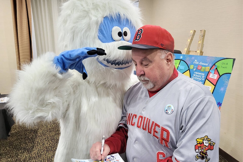 Veteran Morning Star reporter Roger Knox (right) interviews Yeti, the newest Vernon Winter Carnival mascot, at the Carnival Media Night Wednesday, Jan. 10, at the Holiday Inn Express and Suites. (Laurell Cornell Photo) 