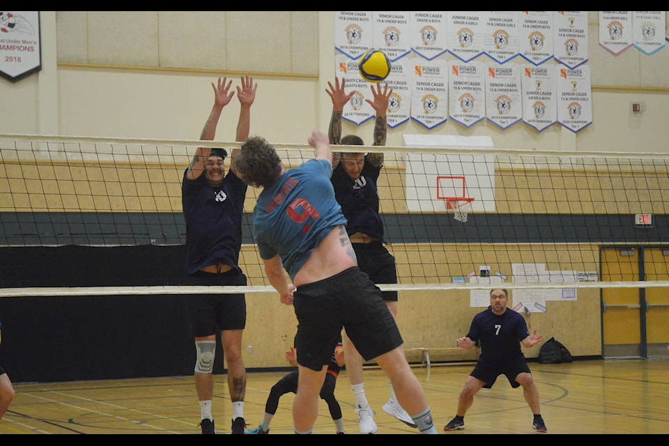 Carson Roche, left, and Blake McNeil try to block the kill of Andrew Goodwin. James McCarthy/NNSL photo 