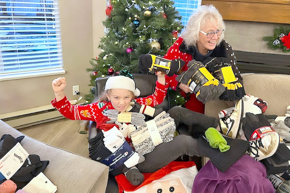 ‘Elf’ Arabella and coordinator Beverly Genge celebrated a new record of more than 700 warm winter socks collected for the homeless at Chartwell Green clubhouse in Walnut Grove. (Special to 91ԭ Advance Times) 