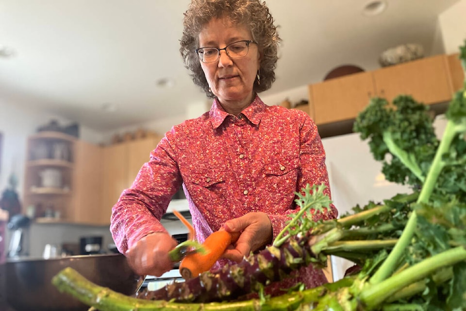 Saanich backyard grower Natanis Christensen crafts a kale salad for a hearty winter lunch with her own greens and other produce. (Christine van Reeuwyk/News Staff) 
