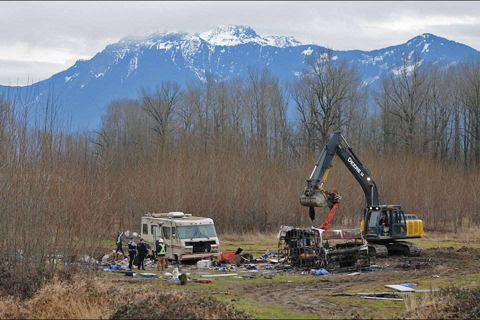 An excavator is seen at the Island 22 encampment on Tuesday, Jan. 30, 2024. That day, several garbage bins were brought onto the site, plus the excavator was removing discarded items and clearing pathways. The eviction deadline is Wednesday, Jan. 31, 2024. (Jenna Hauck/ Chilliwack Progress) 