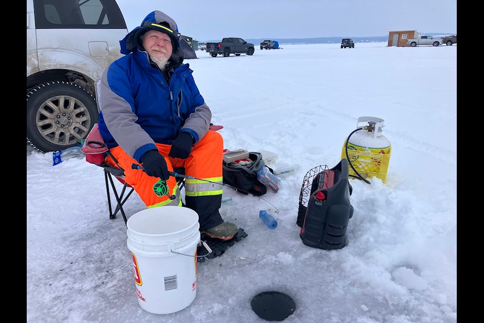 Larry Boles enjoys a mild Saturday afternoon during the Big Jig Ice Fishing Derby on Sylvan Lake, which ran Jan. 19-21. Mark Weber/Sylvan Lake News 