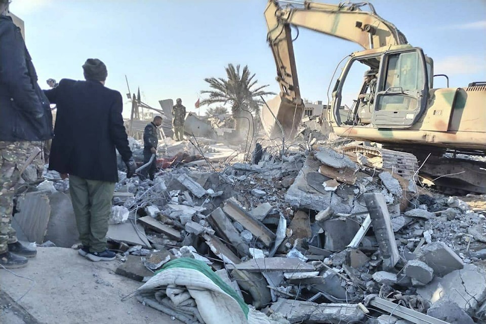 Members of Iraqi Shiite Popular Mobilization Forces clean the rubble after a U.S. airstrike in al-Qaim, Iraq, Saturday, Feb. 3, 2024. The U.S. Central Command said in a statement on Friday that the U.S. forces conducted airstrikes on more than 85 targets in Iraq and Syria against Iran’s Islamic Revolutionary Guards Corps and affiliated militia groups. (AP Photo/Popular Mobilization Forces Media Office) 