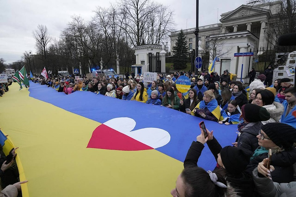 Ukrainians and Poles march with a giant Ukrainian flag in protest of Russia’s military aggression against Ukraine on the second anniversary of the war, in front of the Russian Embassy in Warsaw, Poland, Saturday Feb. 24, 2024. (AP Photo/Czarek Sokolowski) 