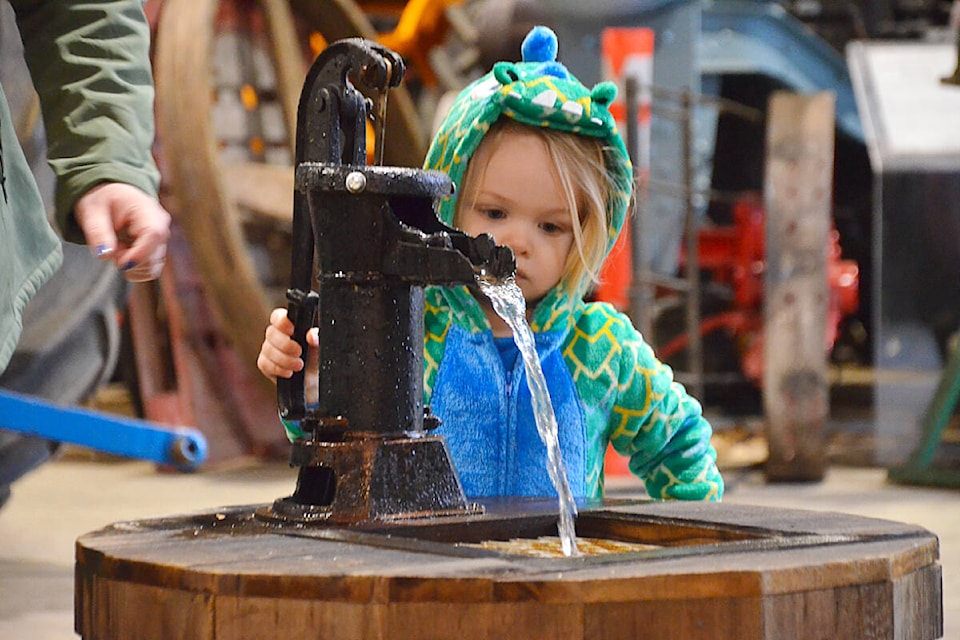 Charlie, two, checked out a hand pump at the BC Farm Museum in Fort Langley on Family Day last year. (Langley Advance Times files) 