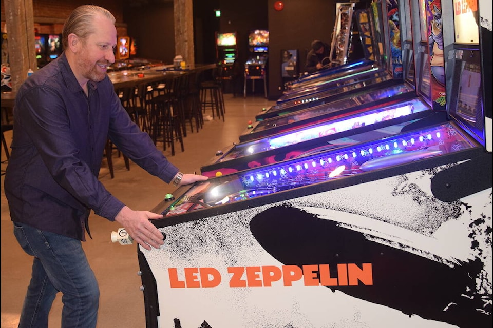 Pinhalla Pinball Pizzeria operations manager Mark Carrillo plays pinball on one of the 33 machines at the arcade. (Brendan Mayer/News Staff) 