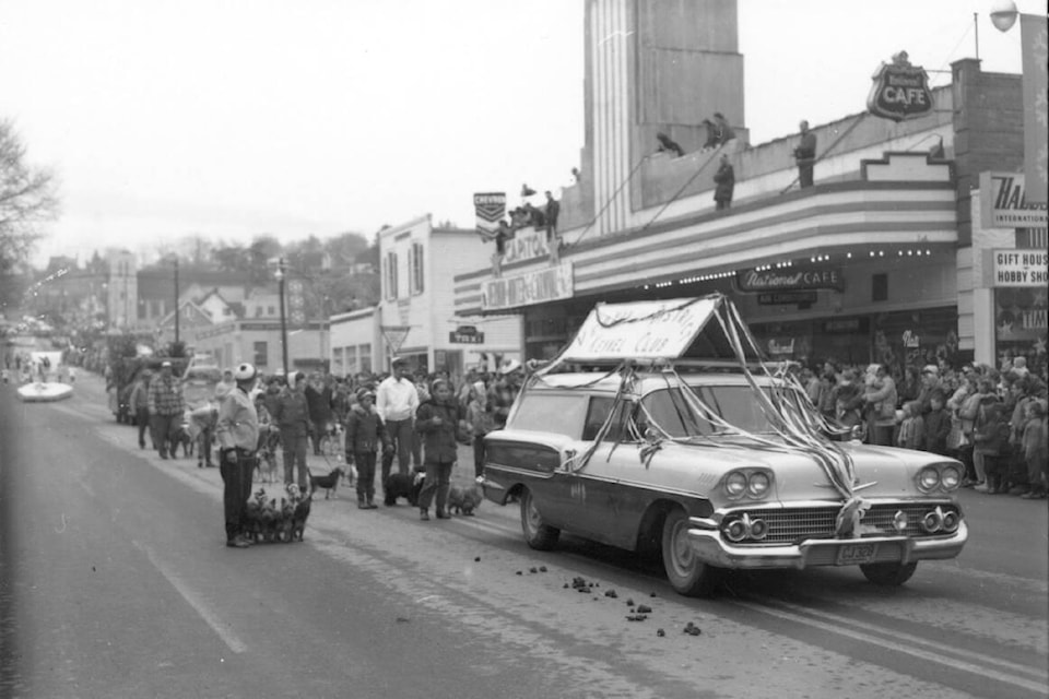 The Vernon and District Kennel Club – complete with four-legged participants – wheels and strolls down 30th Avenue in the second annual Vernon Winter Carnival Parade in 1962. Other landmarks in the photo include the old National Café, the Capitol (now Towne) Theatre and the old Trinity United Church in the background. (Museum and Archive of Vernon photo #6301) 