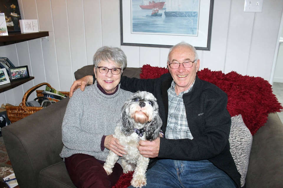 Suzanne and Jim Prest share the love on Valentine’s Day with their pooch, Chloe. (Photo by Don Bodger) 