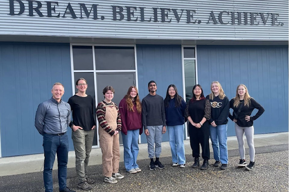 Vernon School District student trustees Luke Friesen (from left), Kaylee Peters, Tobias McRae, Oceane Mignon, Anabhav Kishore, Selynn Choo, Nevaeh Kim, Ella Fisher, and Angelina Van Dusen gather at the district office under the new logo. Rebranding within the school district took a year-and-a-half, and is now complete. (Contributed) 